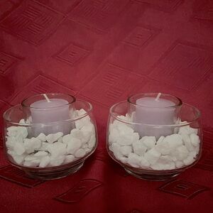 2 votive candle holders perched in white marble chips set in vintage glass dish